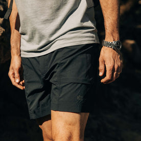 fit model walking in The Challenge Cargo Short in Black, Bottoms by Taylor Stitch