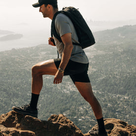 fit model hiking wearing The Challenge Cargo Short in Black, Bottoms by Taylor Stitch