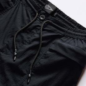 material shot of the drawstring on The Challenge Cargo Short in Black, Bottoms by Taylor Stitch