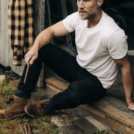 fit model sitting in The Democratic Jean in Black Nihon Menpu Selvage, Bottoms by Taylor Stitch