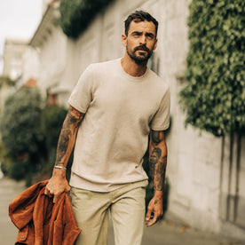 fit model walking wearing The Heavy Bag Waffle Short Sleeve in Oat Heather, Knits by Taylor Stitch