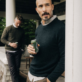 fit model holding a beer in The Lodge Sweater in Black Pine, Knits by Taylor Stitch