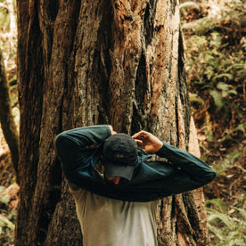 fit model putting on The Merino Half Zip in Forest, Knits by Taylor Stitch