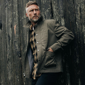 fit model with his hands in the pockets of The Pathfinder Jacket in Fatigue Olive Dry Wax, Outerwear by Taylor Stitch