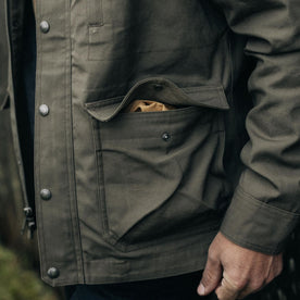 fit model showing off pockets on The Pathfinder Jacket in Fatigue Olive Dry Wax, Outerwear by Taylor Stitch