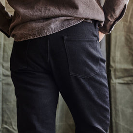 fit model showing the back of The Slim Jean in Black Nihon Menpu Selvage, Bottoms by Taylor Stitch