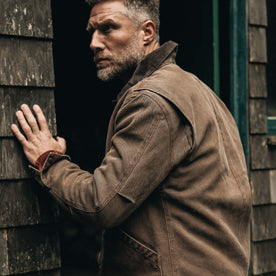 fit model holding the wall wearing The Workhorse Jacket in Aged Penny Chipped Canvas, Outerwear by Taylor Stitch