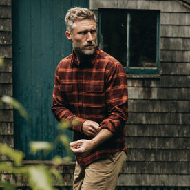 fit model adjusting his sleeves in The Yosemite Shirt in Burnt Toffee Plaid, Wovens by Taylor Stitch