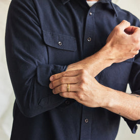 fit model adjusting the cuffs on The Yosemite Shirt in Dark Navy, Wovens by Taylor Stitch