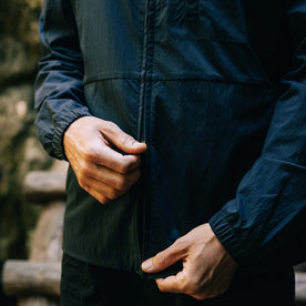 fit model zipping up The Deploy Packable Shell in Dark Navy, Outerwear by Taylor Stitch