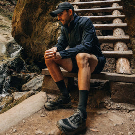 fit model sitting on stairs wearing The Deploy Packable Shell in Dark Navy, Outerwear by Taylor Stitch