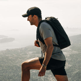 fit model walking wearing The Performance TAC Hat in Black, Accessories by Taylor Stitch