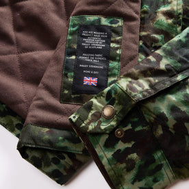 material shot of the Halley Stevensons material patch on The Venture Jacket in Painted Camo Waxed Canvas, Outerwear by Taylor Stitch