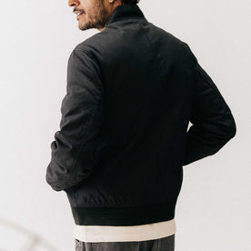 fit model showing the back of The Insulated Bomber Jacket in Coal Dry Wax, Outerwear by Taylor Stitch