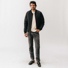 fit model standing in The Insulated Bomber Jacket in Coal Dry Wax, Outerwear by Taylor Stitch