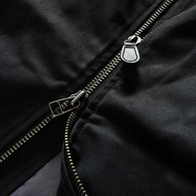 material shot of the two-way YKK zipper on The Insulated Bomber Jacket in Coal Dry Wax, Outerwear by Taylor Stitch