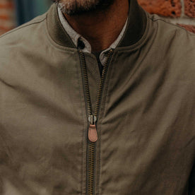 fit model showing the zipper front of The Insulated Bomber Jacket in Fatigue Olive Dry Wax, Outerwear by Taylor Stitch