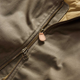 material shot of the two-way zipper on The Insulated Bomber Jacket in Fatigue Olive Dry Wax, Outerwear by Taylor Stitch