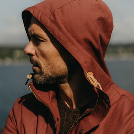 fit model with his hood on wearing The Explorer Jacket in Red Wine Dry Wax, Outerwear by Taylor Stitch