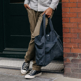 fit model holding The Foundation Tote in Organic Navy, Accessories by Taylor Stitch