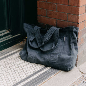 editorial image of The Foundation Tote in Organic Navy leaning against the wall, Accessories by Taylor Stitch