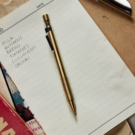 editorial image of The Mechanical Pencil in Brass on a sheet of paper, Accessories by Taylor Stitch