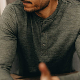 fit model showing off the buttons on The Merino Henley in Heather Army, Knits by Taylor Stitch