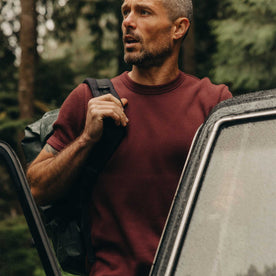 fit model getting into a car wearing The Organic Cotton Short Sleeve Crew in Burgundy Waffle, Knits by Taylor Stitch