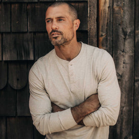 fit model with his arms crossed wearing The Organic Cotton Henley in Heather Oat, Knits by Taylor Stitch