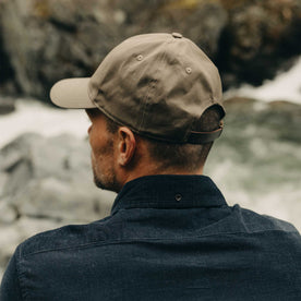 fit model showing off the back of The Pathfinder Cap in Fatique Olive Dry Wax, Accessories by Taylor Stitch