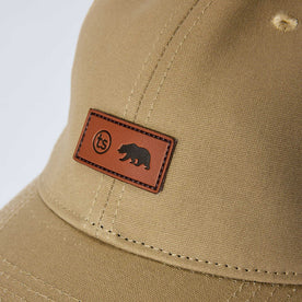 editorial image of the tag on The Pathfinder Cap in Khaki Dry Wax, Accessories by Taylor Stitch