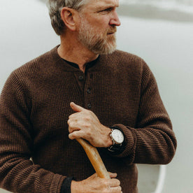 fit model holding a oar wearing The Sidecountry Sweater in Heather Coffee Merino Waffle, Knits by Taylor Stitch