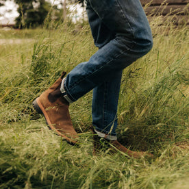 fit model walking in The Slim Jean in Mid Wash Organic Selvedge, Bottoms by Taylor Stitch