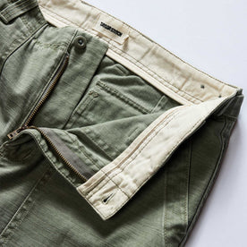 material shot of the zipper fly on The Surplus Pant in Field Olive Reverse Sateen, Bottoms by Taylor Stitch