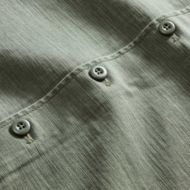 material shot of the buttons on The Surplus Shirt in Field Olive Reverse Sateen, Wovens by Taylor Stitch