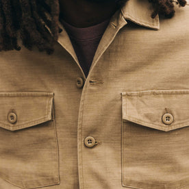 fit model showing off buttons on The Surplus Shirt in Khaki Reverse Sateen, Wovens by Taylor Stitch