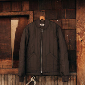 editorial image of The Able Jacket in Soil Quilted Nylon on a hanger, Outerwear by Taylor Stitch