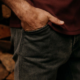 fit model with his hand in his pocket wearing The Camp Pant in Coal Chipped Canvas, Bottoms by Taylor Stitch