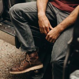 fit model sitting wearing The Camp Pant in Coal Chipped Canvas, Bottoms by Taylor Stitch