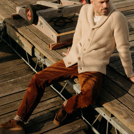 fit model sitting wearing The Carnegie Pant in Bourbon Corduroy, Bottoms by Taylor Stitch