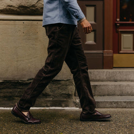 fit model walking wearing The Carnegie Pant in Soil Corduroy, Bottoms by Taylor Stitch