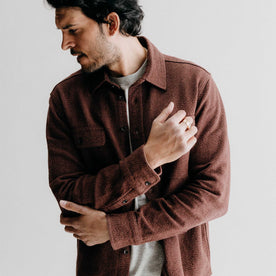 fit model adjusting the sleeves on The Ledge Shirt in Burgundy Linen Tweed, Wovens by Taylor Stitch