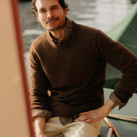 fit model sitting wearing The Lodge Sweater in Timber Donegal, Knits by Taylor Stitch