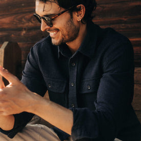 fit model sitting wearing The Ledge Shirt in Dark Navy Linen Tweed, Wovens by Taylor Stitch