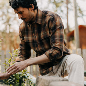 fit model kneeling wearing The Yosemite Shirt in Bonfire Plaid, Wovens by Taylor Stitch