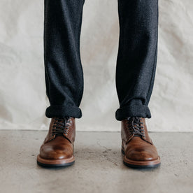 fit model standing in The Carnegie Pant in Charcoal Heather Wool, Bottoms by Taylor Stitch