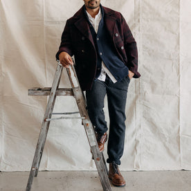 fit model leaning against a ladder in The Carnegie Pant in Charcoal Heather Wool, Bottoms by Taylor Stitch