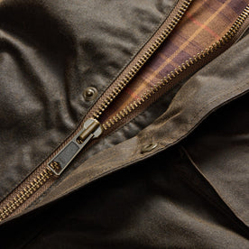 material shot of the YKK zipper on The Clutch Jacket in Soil Waxed Canvas, Outerwear by Taylor Stitch