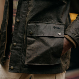 fit model showing the pockets on The Clutch Jacket in Soil Waxed Canvas, Outerwear by Taylor Stitch