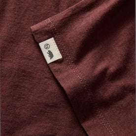 material shot of the hem and TS label on The Cotton Hemp Long Sleeve Tee in Burgundy, Knits by Taylor Stitch